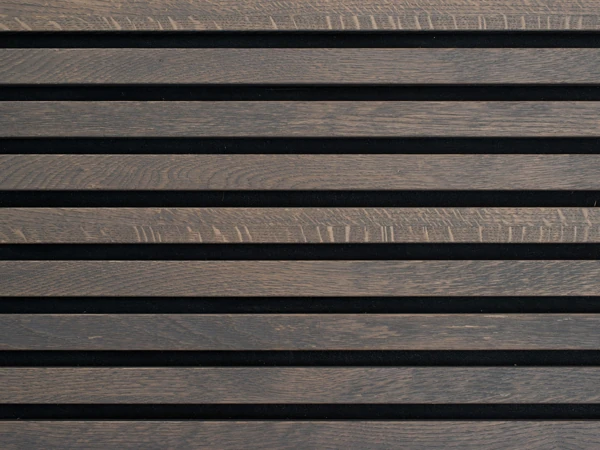grey-stained oak wood slat wall paneling with a subtle wood grain and black felt backing
