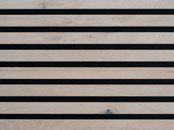 pale oak wood slat wall paneling with a smooth finish and black felt backing